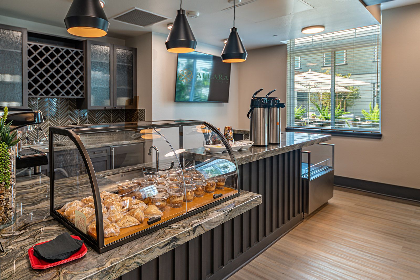 Interior view of Allara Senior Living community featuring a bakery shop with modern architecture.