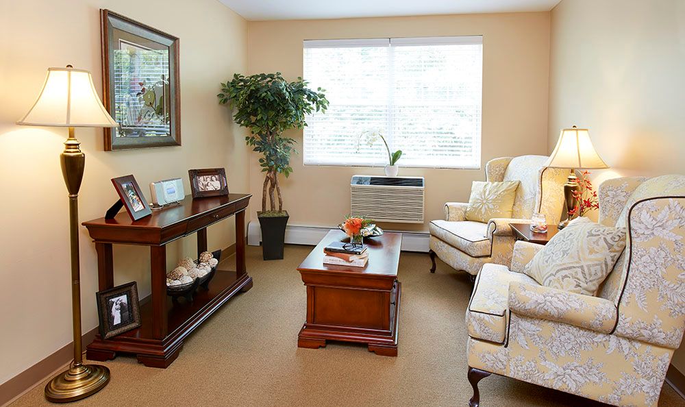 Senior living community room at Tatnuck Park, Worcester with cozy furniture and home decor.
