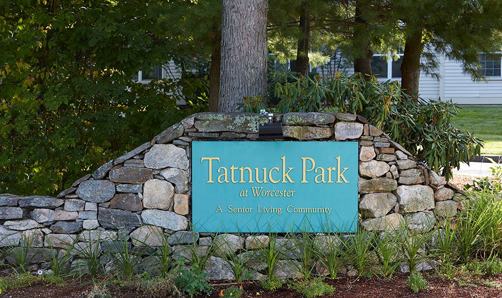 Senior living community, Tatnuck Park at Worcester, featuring slate walkways and lush vegetation.