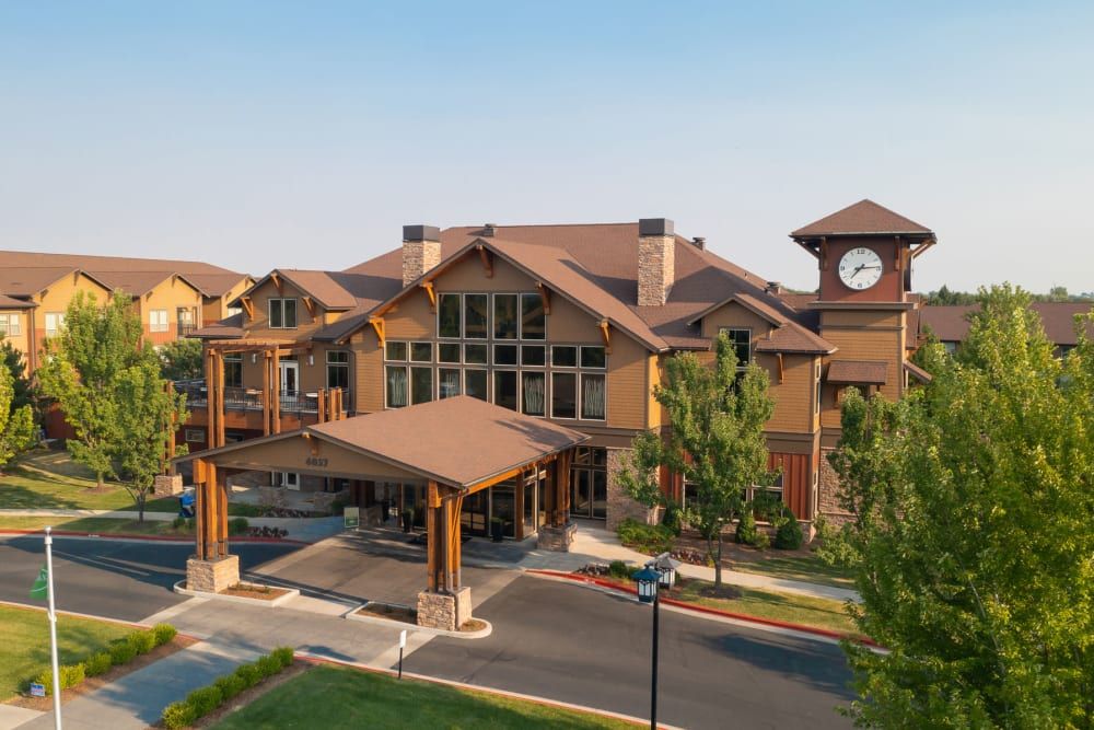Suburban senior living community, Touchmark At Meadow Lake Village, featuring architecture with a clock tower.