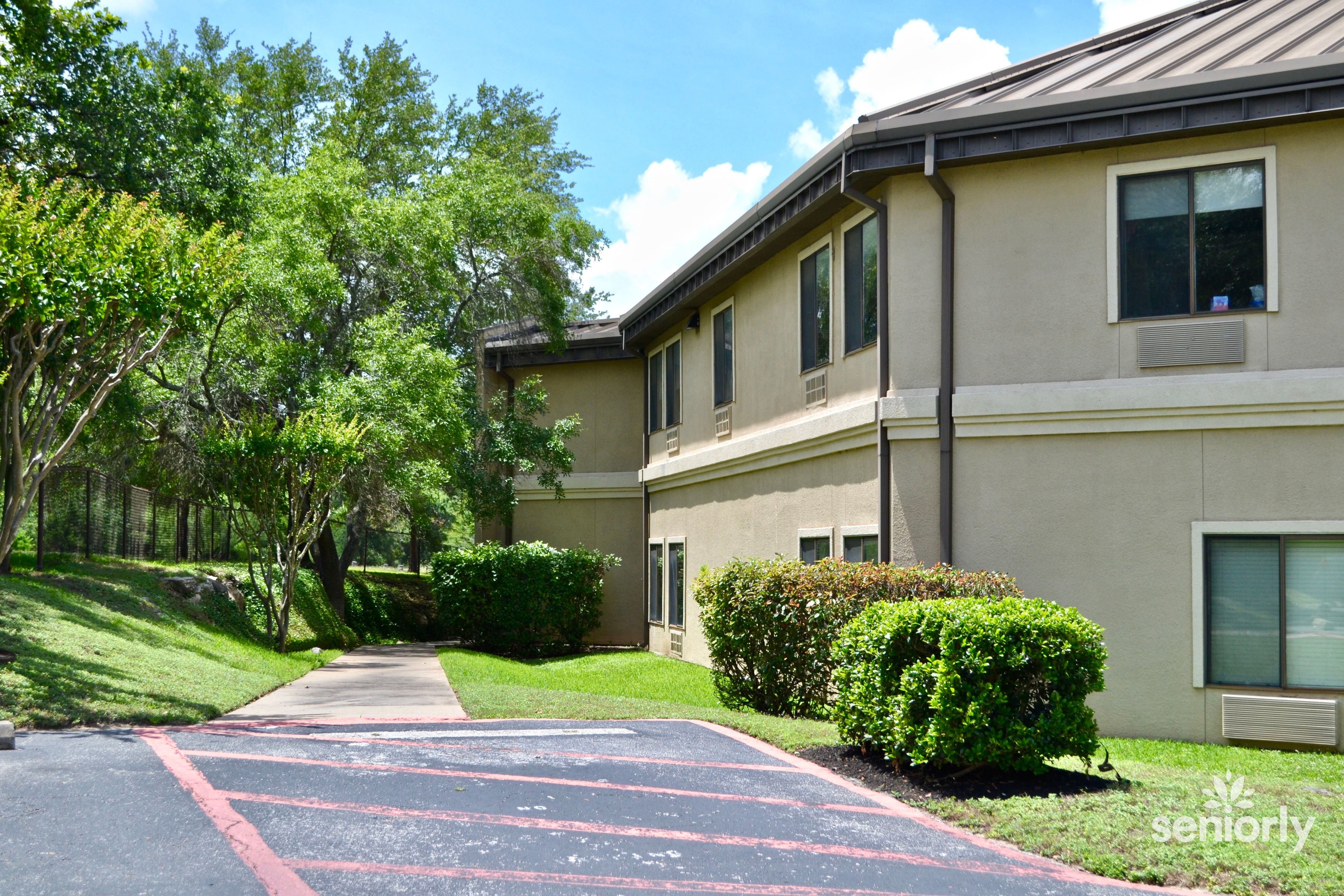 Austin's Heartland Health Care Center, a senior living community nestled in a lush suburban setting.