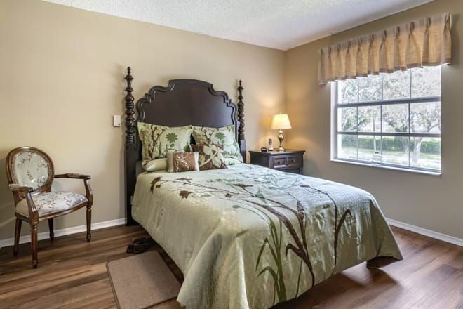 Interior view of a cozy bedroom at Brookdale West Palm Beach senior living community.