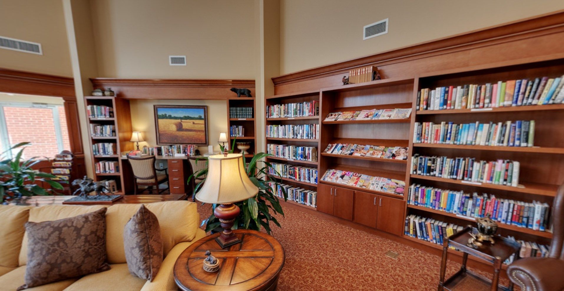 Interior view of Abernethy Laurels senior living community featuring a cozy library room with stylish decor.