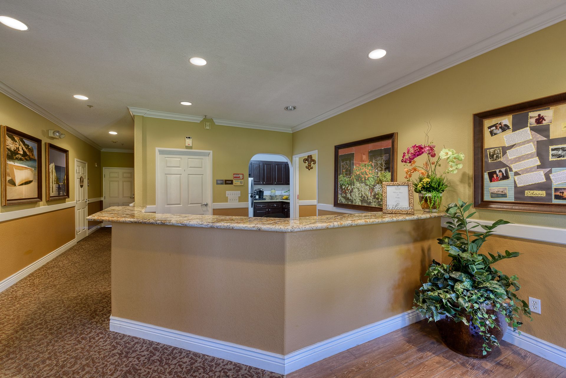 Interior view of Pacifica Senior Living Newport Mesa featuring hardwood floors, furniture, and art.
