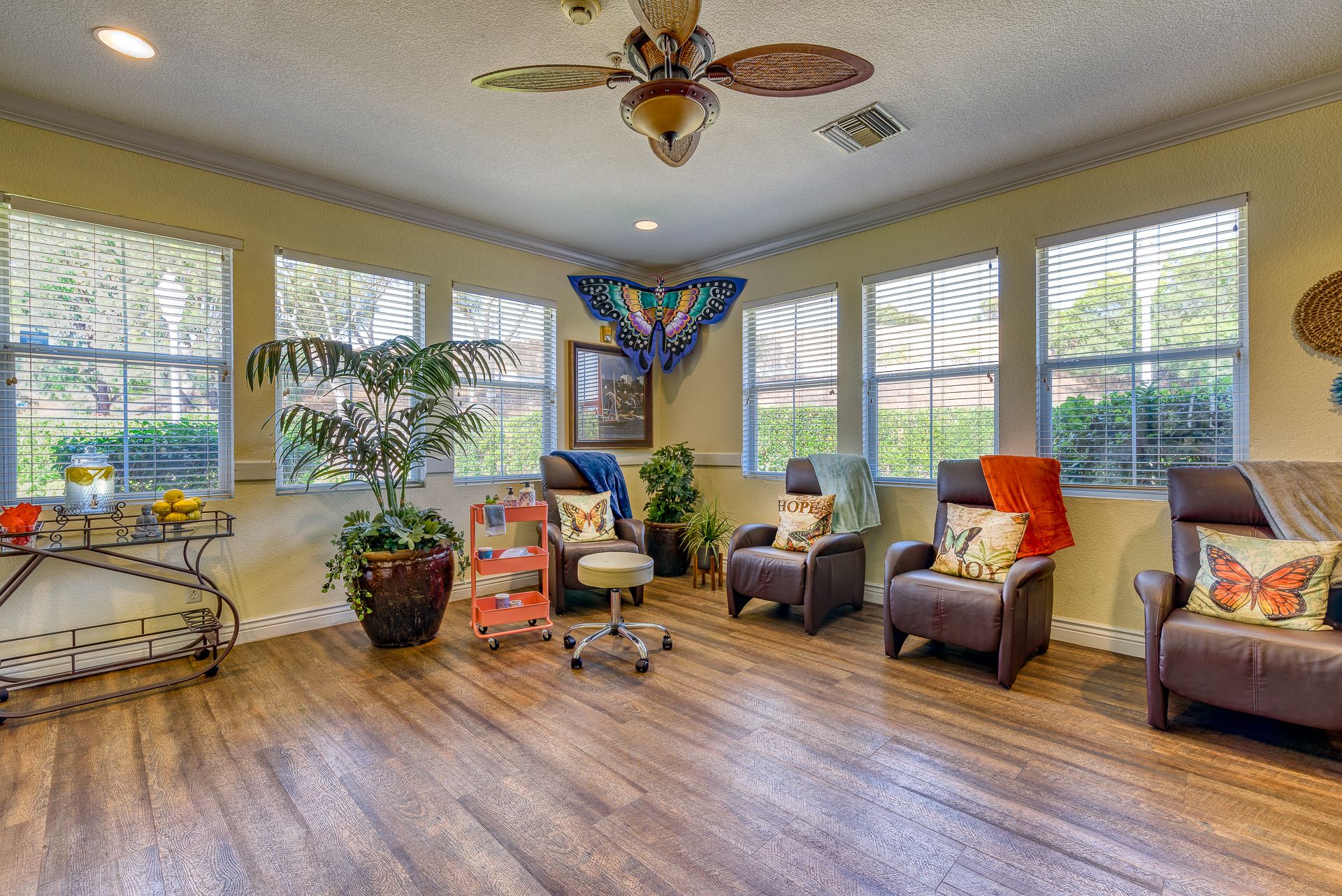 Interior view of Pacifica Senior Living Newport Mesa featuring hardwood floors, furniture, and home decor.