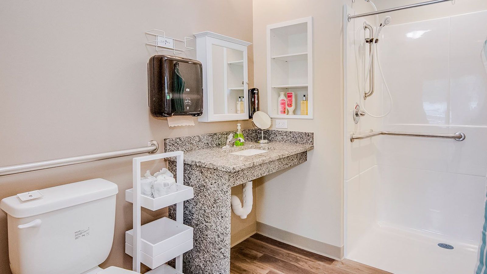 Interior view of a bathroom with modern design at Grandhaven Living Center, featuring a corner sink.