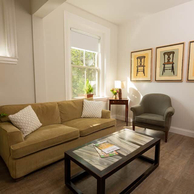 Interior view of The Cambridge Homes senior living community featuring cozy decor and furniture.