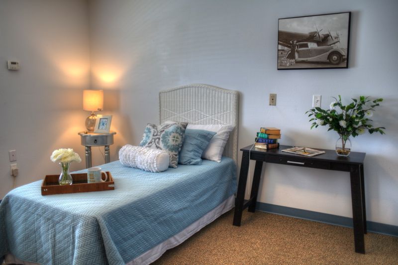 Interior view of Southern Lifestyle Senior Living Center featuring cozy bedroom and living room decor.