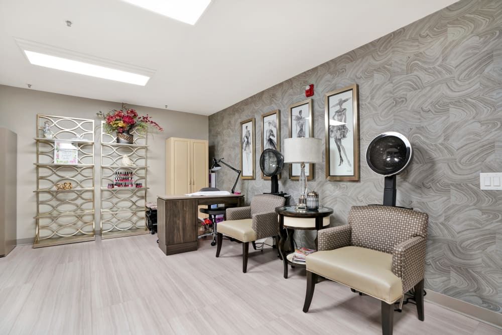 Senior living community interior at The Commons At Dallas Ranch featuring art, decor, and salon.