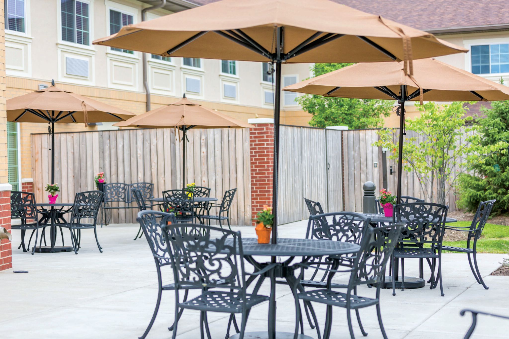 Senior residents enjoying patio dining at Cedar Lake Assisted Living and Memory Care facility.