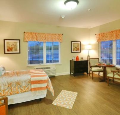 Interior view of a furnished bedroom at The Heritage at Hunters Chase senior living community.