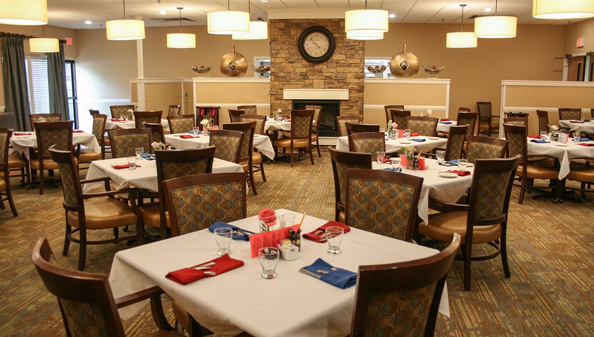 Indoor dining area with furniture and food at Foxwood Springs senior living community.