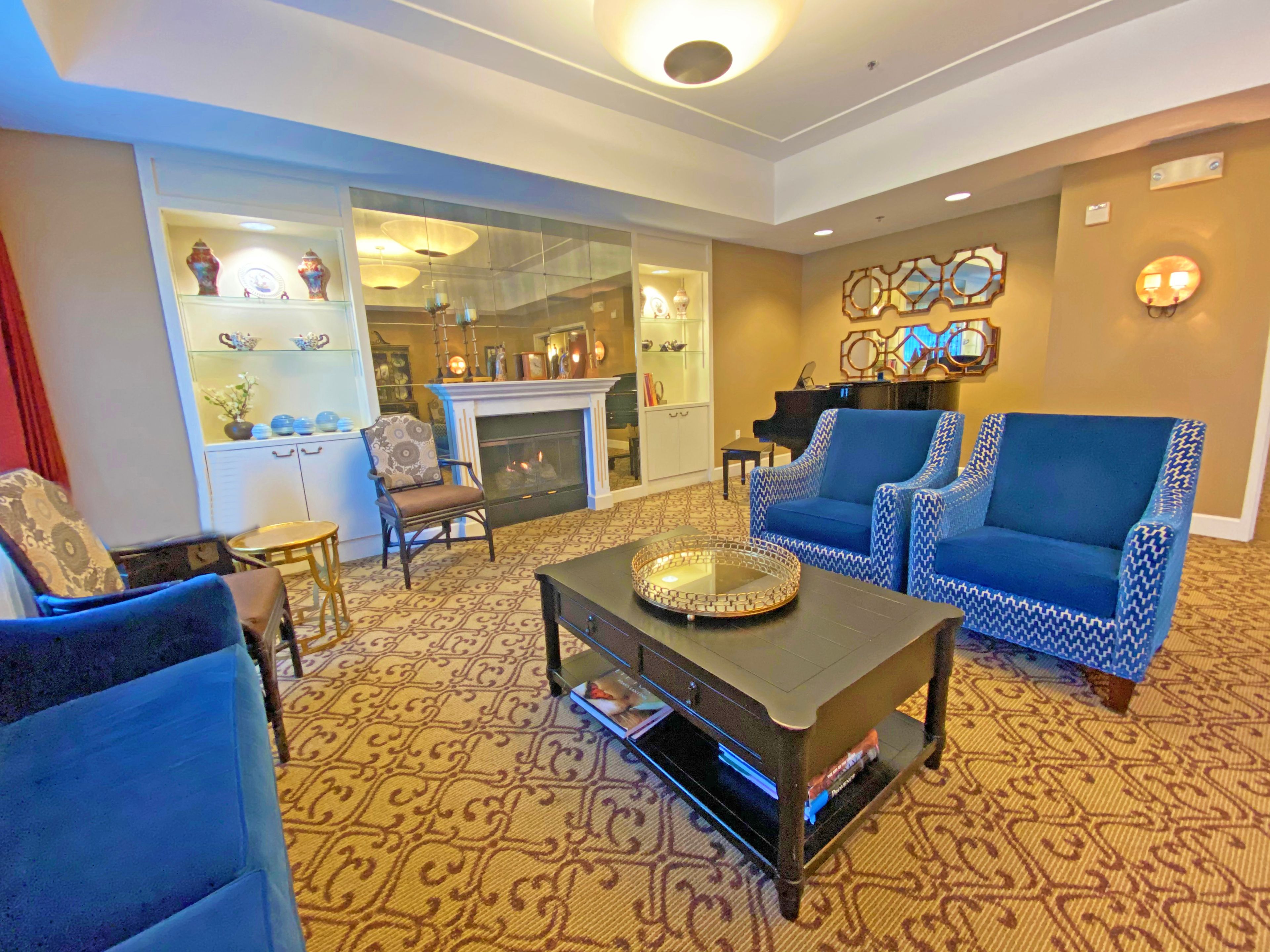 Senior living room interior at AlmaVia of San Francisco with modern furniture and fireplace.