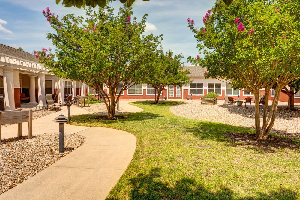 Senior living community, Parmer Woods at North Austin, featuring lush vegetation and urban architecture.