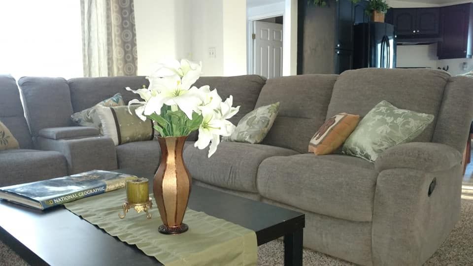 Interior view of MacGregor House senior living community featuring cozy living room decor and appliances.