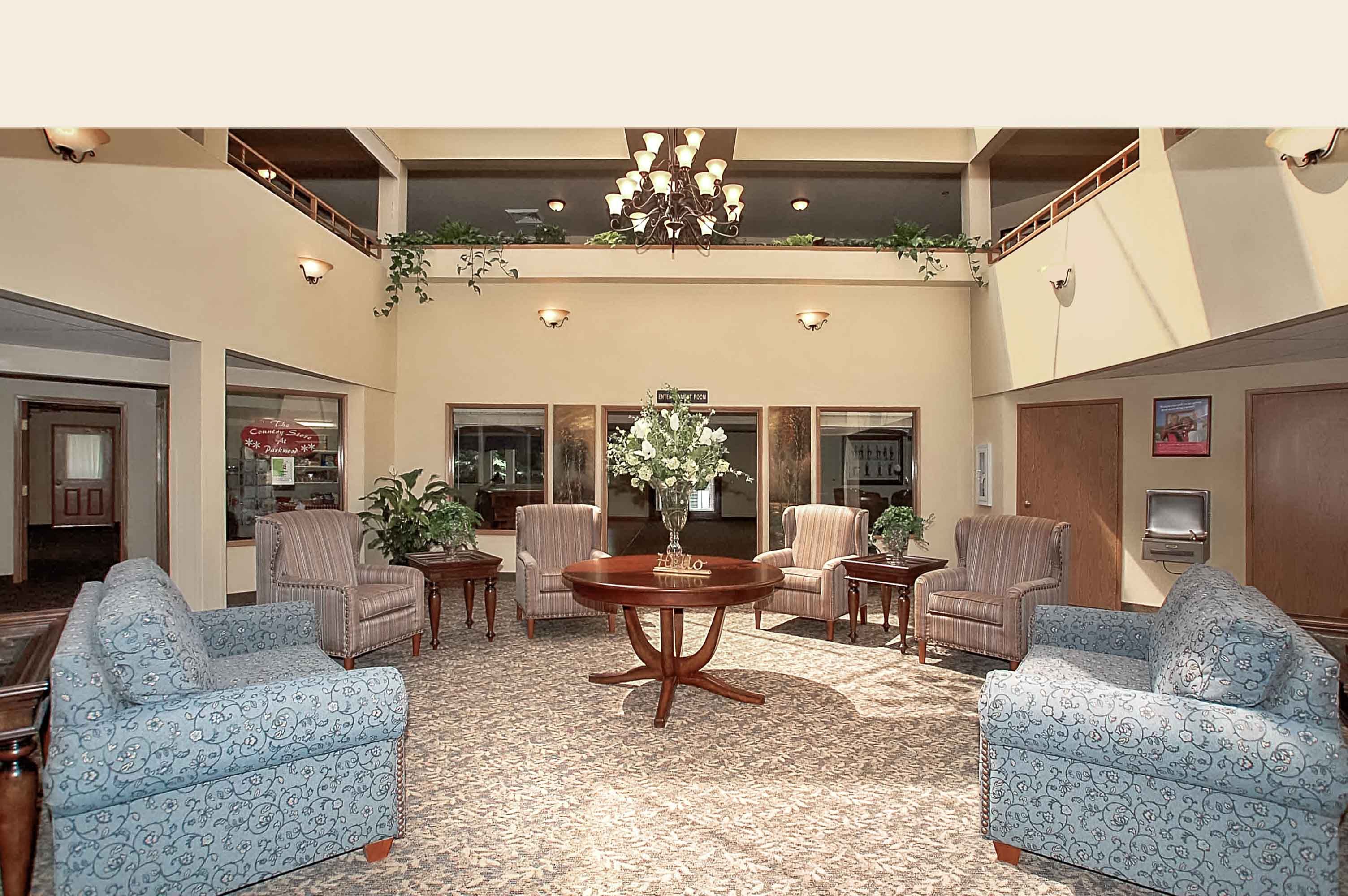 Senior living community reception room at Parkwood Estates with elegant furniture and chandelier.
