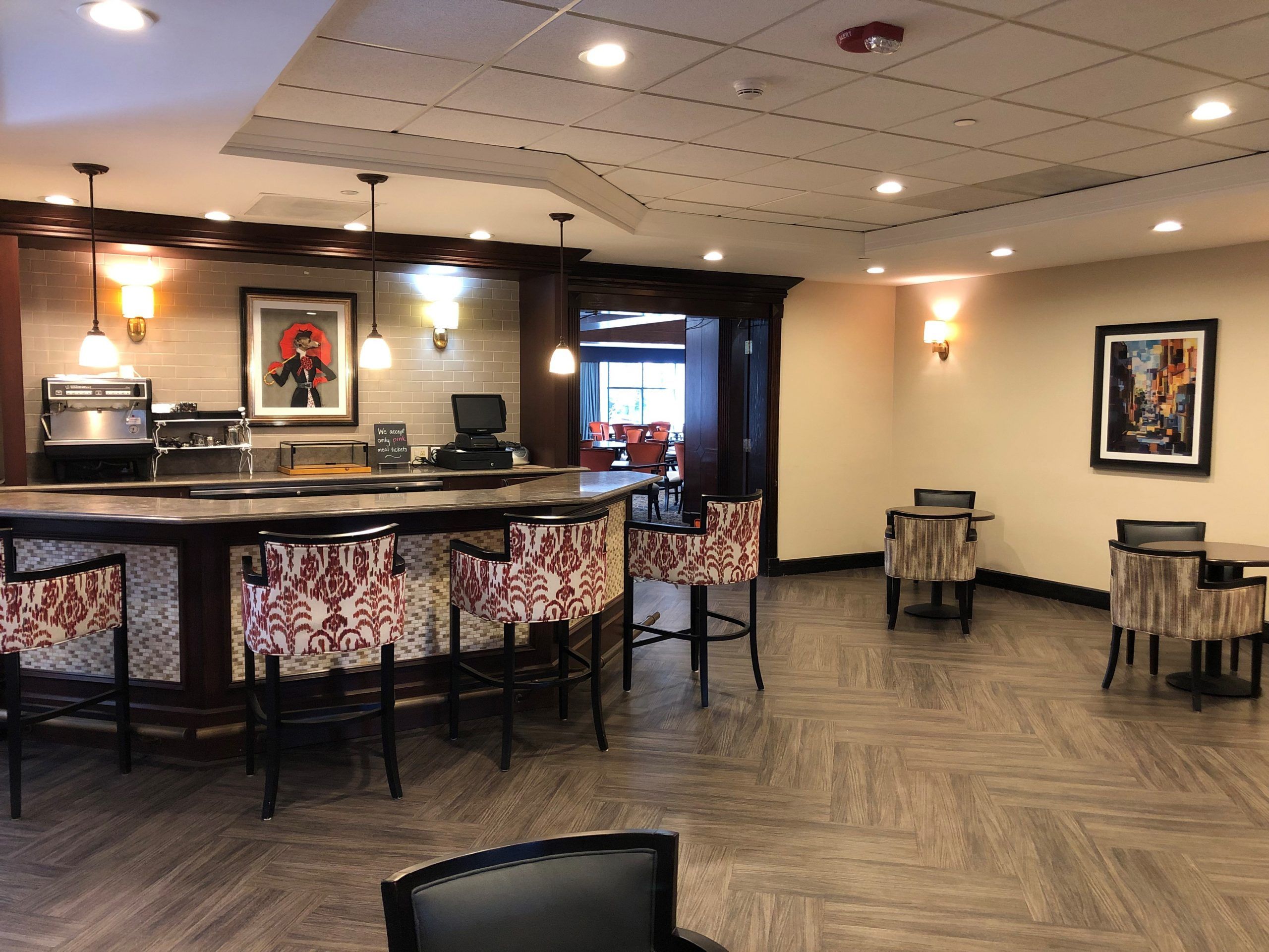 Senior living community lounge at Lincolnwood Place with art, furniture, and computer station.