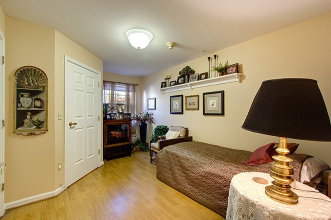 Interior view of Brookdale Reno senior living community featuring cozy bedroom and living room design.
