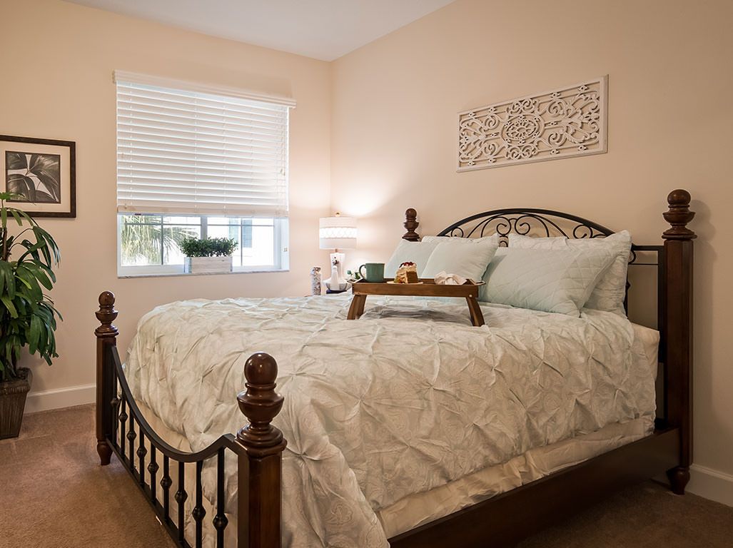 Interior view of a bedroom in The Windsor of Palm Coast senior living community.