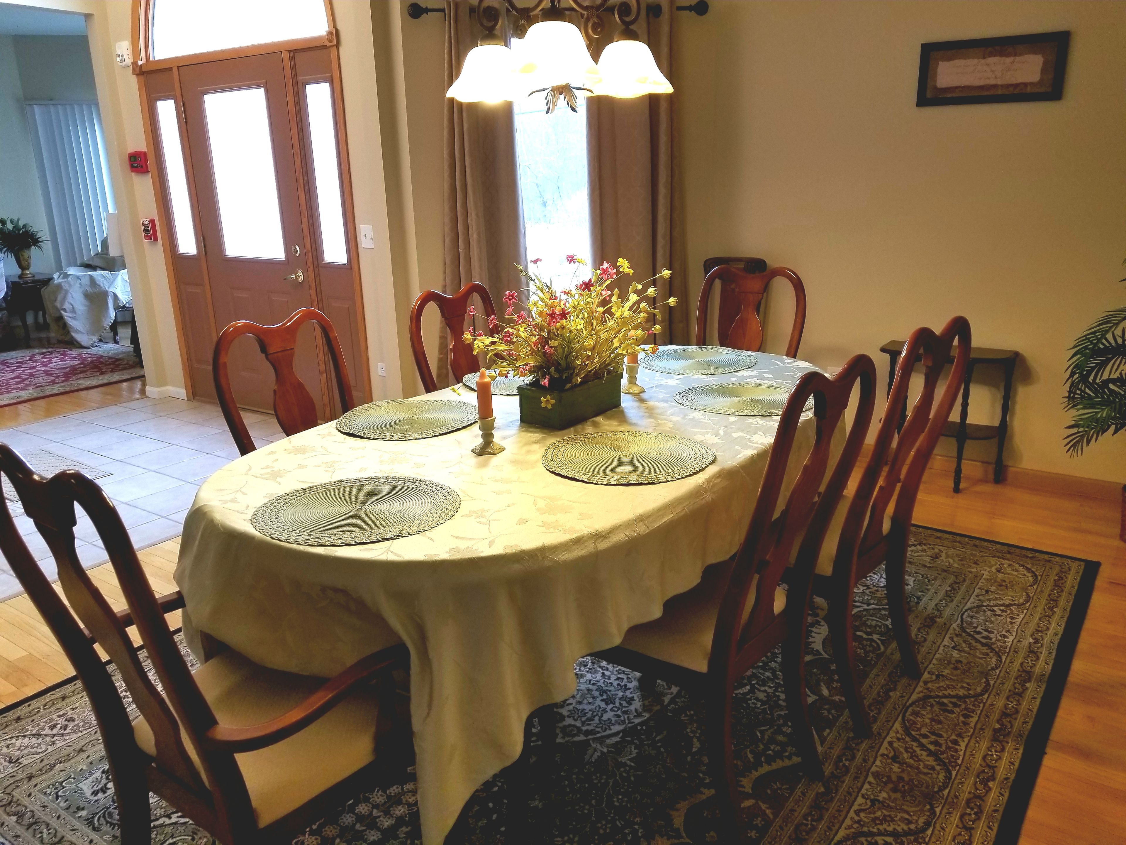 Interior view of Willow Crossing Senior Living featuring dining room with wooden furniture and home decor.