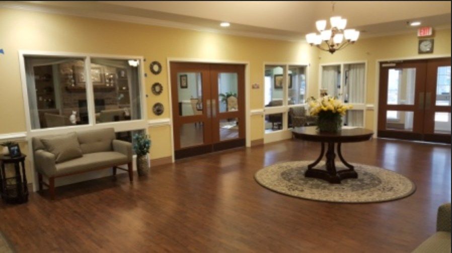 Interior view of Ranson Ridge Assisted Living, showcasing the dining area and living room with elegant decor.