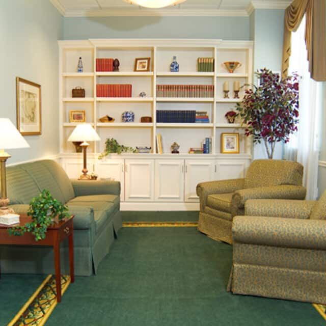 Senior living room at Neville Place Assisted Living, Cambridge, MA, featuring cozy furniture and decor.
