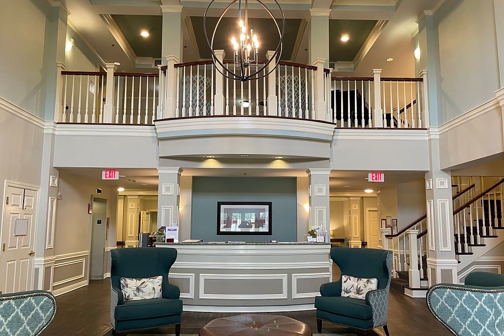 Interior view of The Rutherford Assisted Living featuring modern architecture, art-filled foyer, and cozy living room.