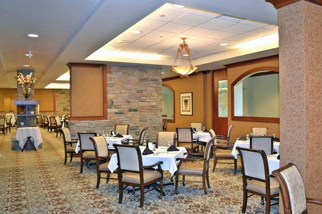 Interior view of Villa St. Benedict senior living community featuring dining room and lounge decor.