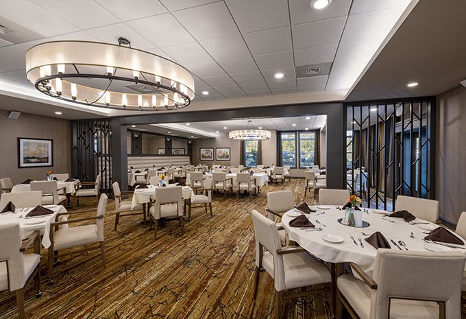 Interior view of Brightview Columbia senior living community featuring dining area and lounge.