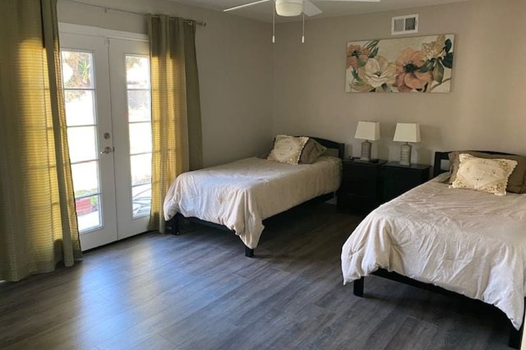 Interior view of a bedroom in Lamp Senior Living Community featuring bed and furniture.