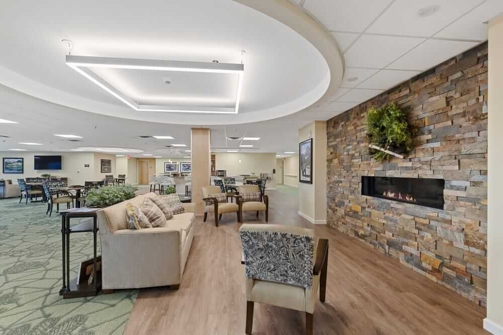 Interior view of Baxter Senior Living room with modern decor, fireplace, and computer facilities.