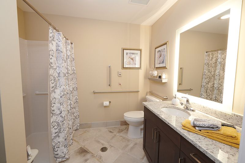 Interior view of a well-designed bathroom with sink and toilet at Allegro Richmond Heights Senior Living.