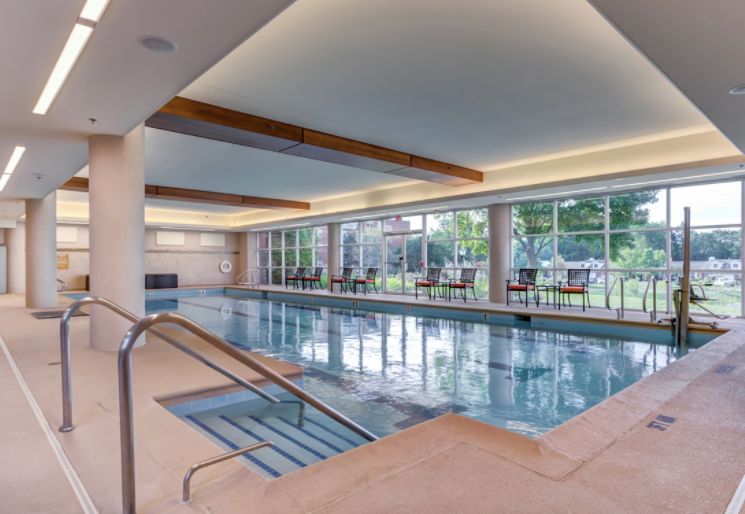 Indoor pool area with modern design at The Moorings of Arlington Heights senior living community.