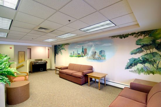 Interior view of Senior Suites Belmont Cragin featuring reception area with modern decor.