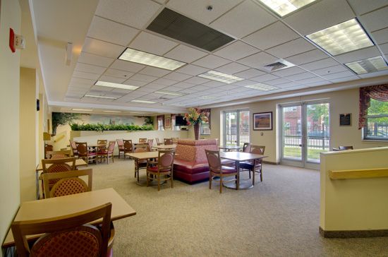 Interior view of Senior Suites Belmont Cragin featuring dining area, reception room, and living room.