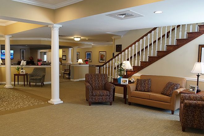 Senior living community Brookdale Emerson featuring modern architecture, indoor living room with furniture.