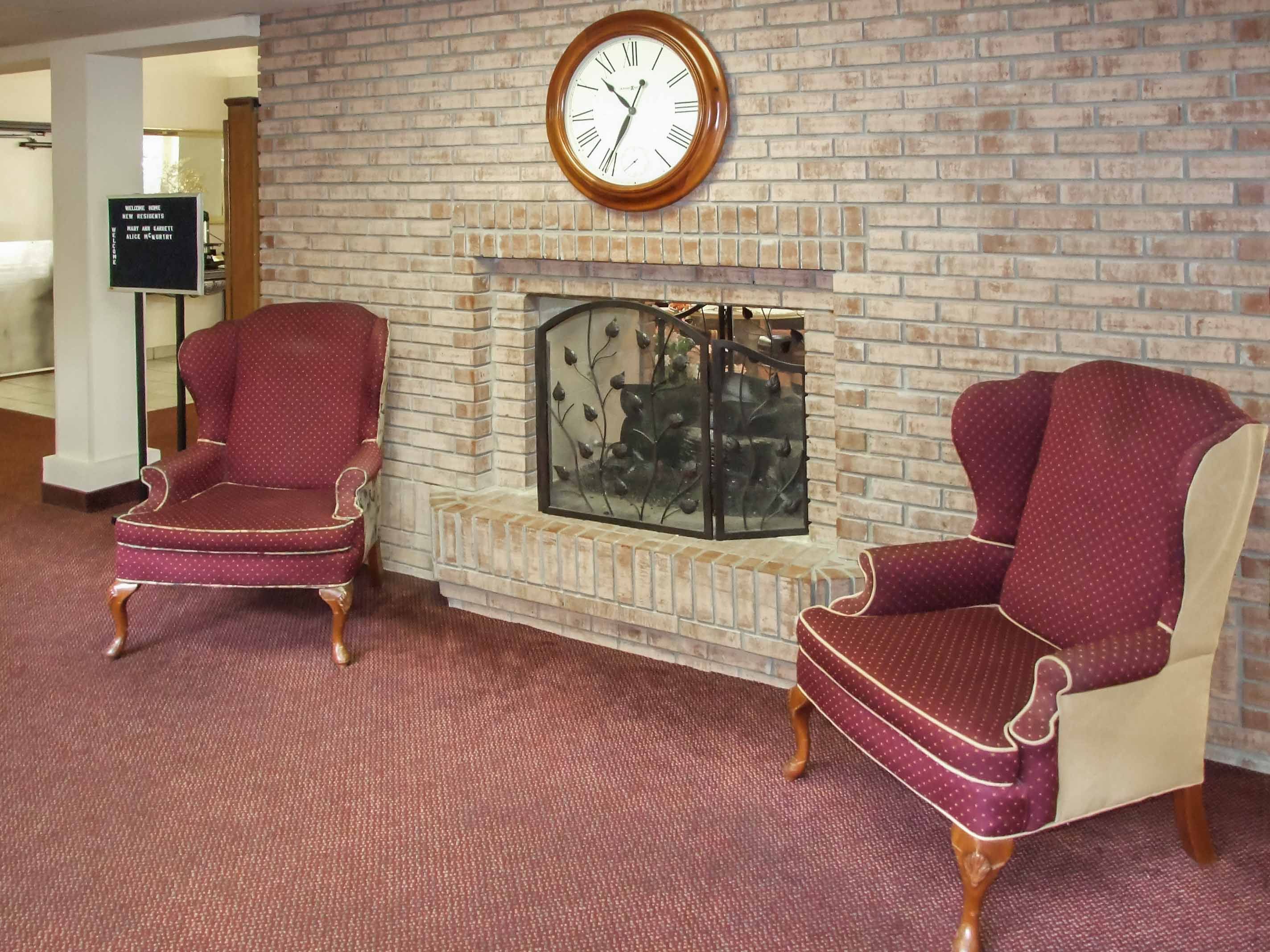 Holiday scene at Willow Park senior living community featuring a cozy living room with furniture and clock.
