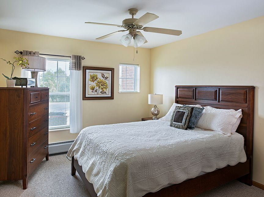 Interior view of a bedroom in American House Cedarlake senior living community with modern decor.