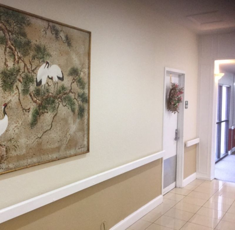 Interior view of Sunny Hills of Sebring senior living community, showcasing art, bird paintings and modern architecture.