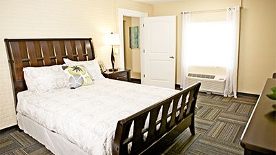 Interior view of a well-furnished bedroom in Skyline Village at Red Mountain senior living community.