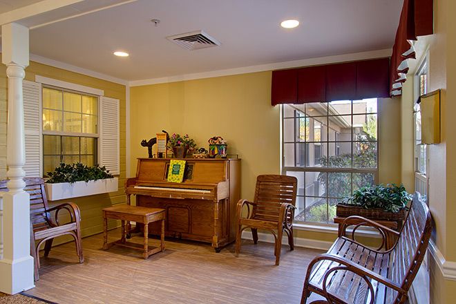 Interior view of Brookdale Reno senior living community featuring hardwood floors, piano, and decor.