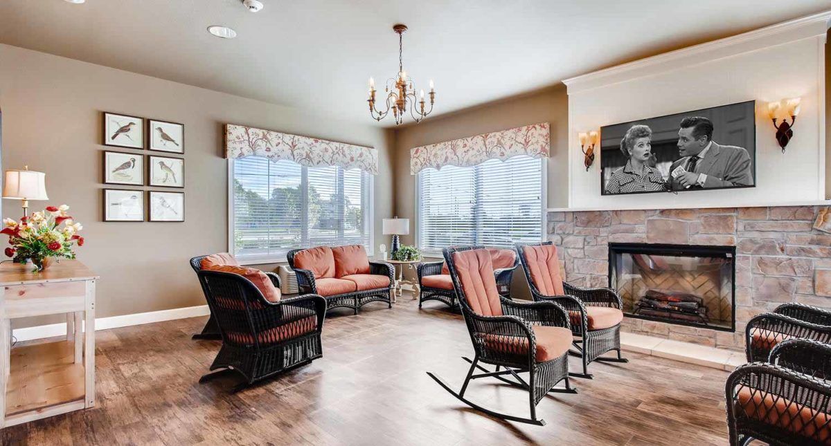 Senior man relaxing in the elegantly designed living area of Creekside Inn with chic decor.