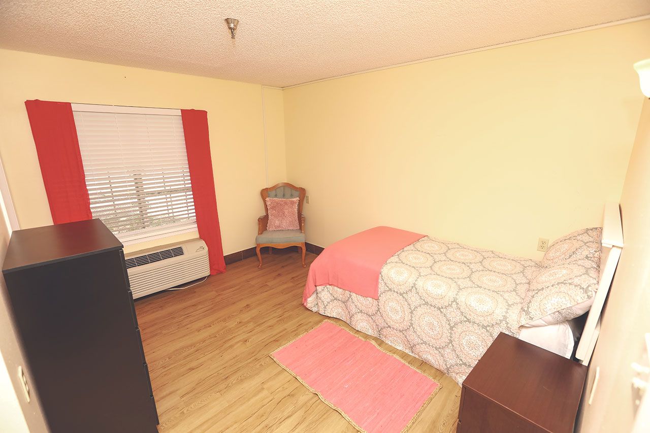 Interior view of a furnished bedroom at Best Care Senior Living in Winter Haven.