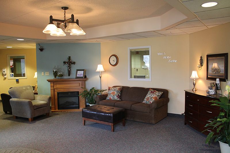 Senior resident relaxing in a well-furnished living room at Christian Care Assisted Living.