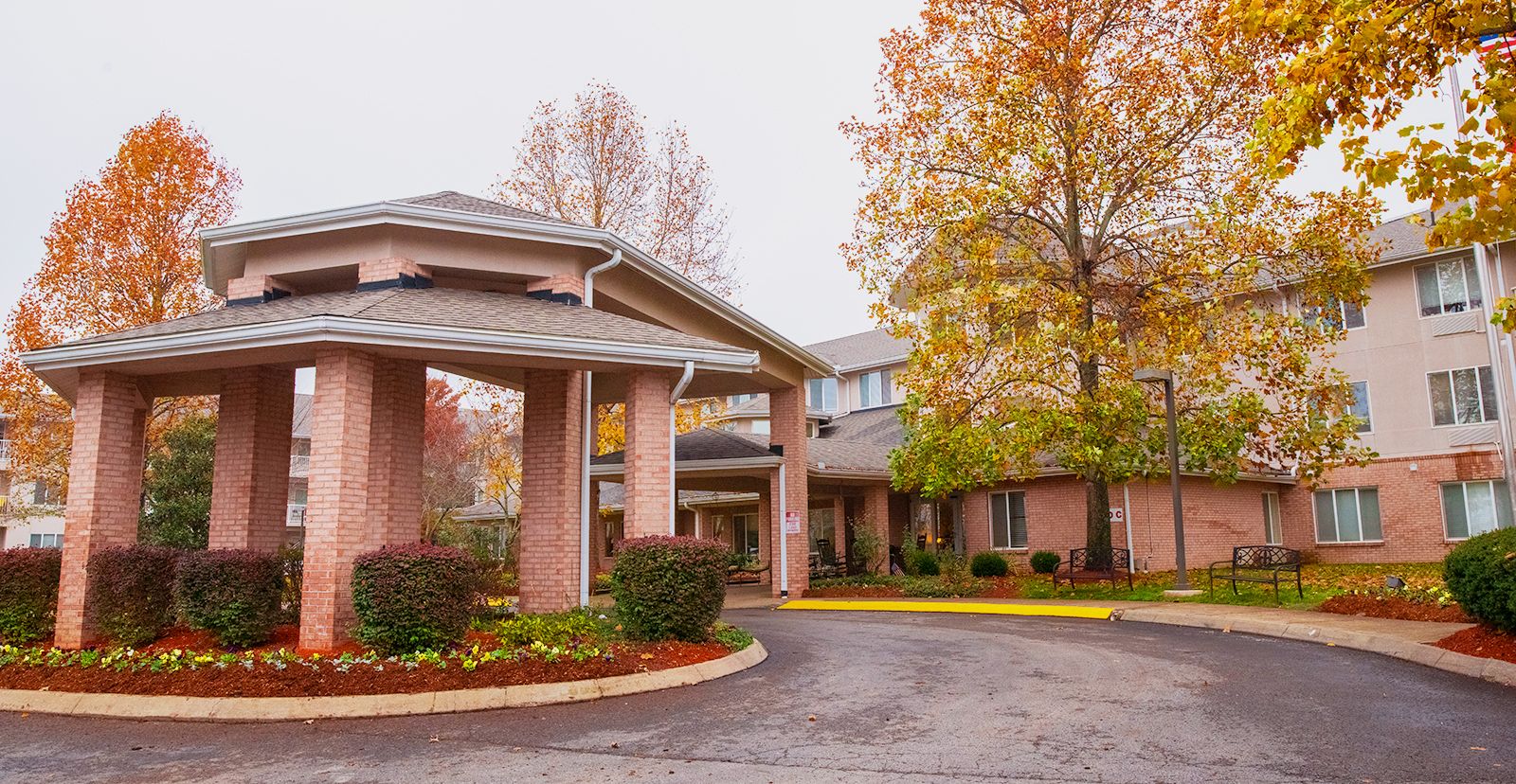 Autumn view of Manor at Steeplechase, a senior living community in a suburban city neighborhood.