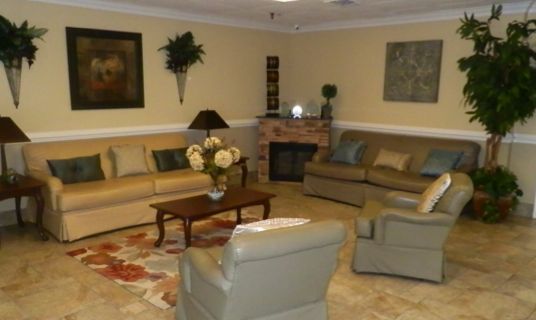 Interior view of Quince Nursing and Rehabilitation Center's living room with elegant decor.