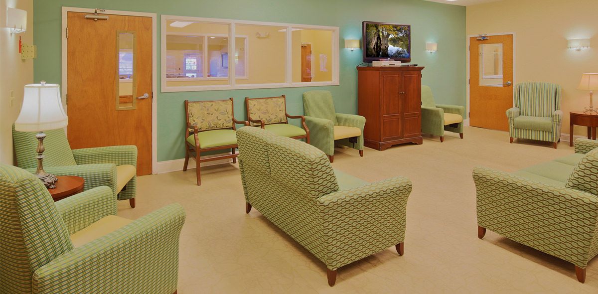 Senior living community Hickory Village's reception room with modern decor, furniture, and electronics.
