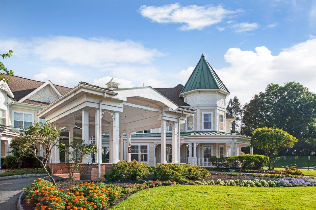 Architectural view of Sunrise of Westfield senior living community house in a suburban area.