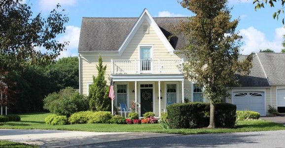 Senior living community, Wiley Christian, featuring cottages, lush lawns, and a neighborhood flag.