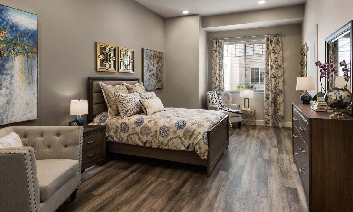 Interior design of a cozy bedroom with elegant furniture at HarborChase of Wellington Crossing senior living community.